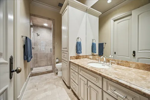 a spacious bathroom with a granite countertop sink mirror and shower