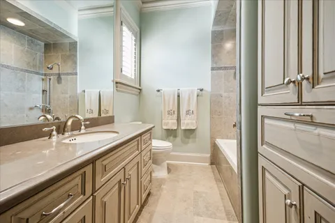 a bathroom with a double vanity sink a mirror and a bathtub