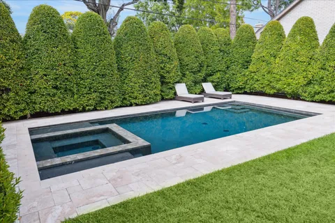 a view of backyard with swimming pool and outdoor space