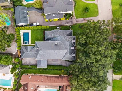an aerial view of a house with a garden and swimming pool