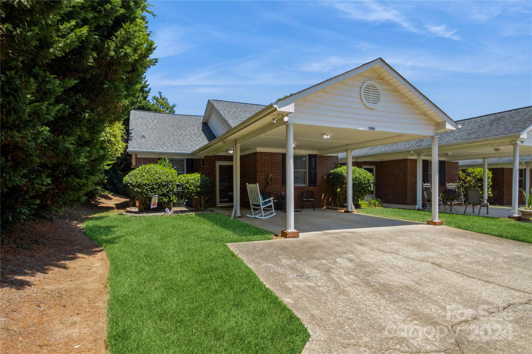 a front view of a house with a yard and garden
