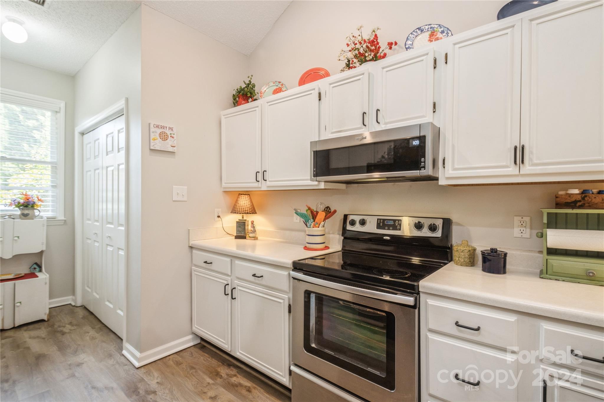 19960 Oak Leaf Circle Cornelius, NC 28031 - Photo 11 of 35 a kitchen with cabinets stainless steel appliances a sink and a stove