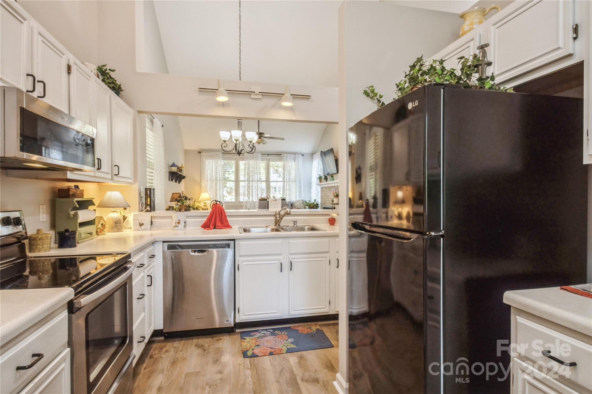 19960 Oak Leaf Circle Cornelius, NC 28031 - Photo 13 of 35 a kitchen with a sink stainless steel appliances and cabinets