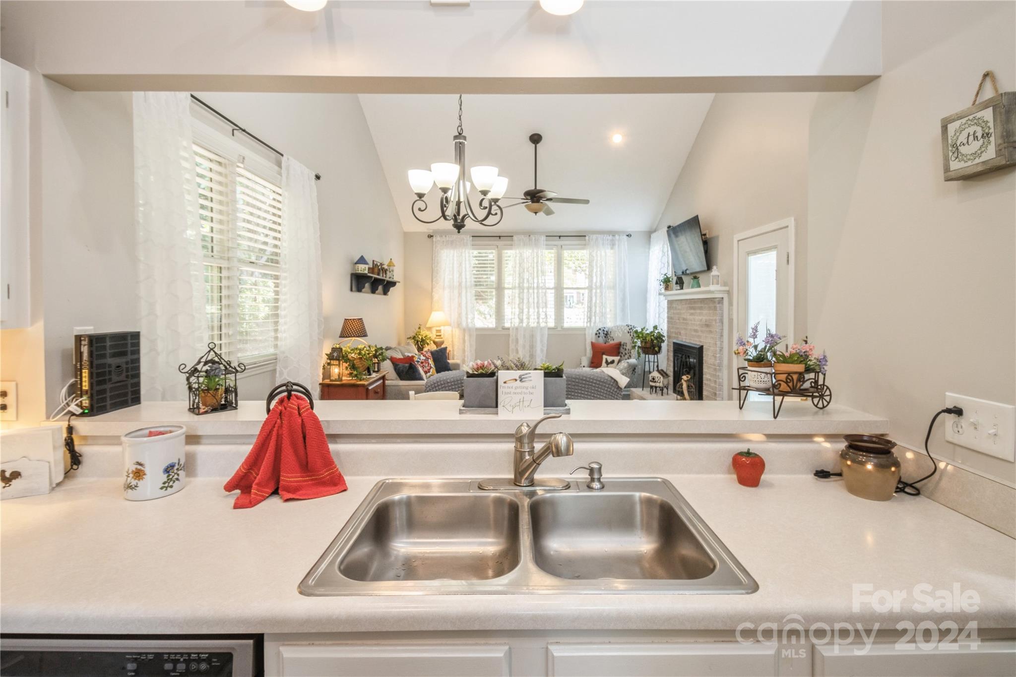 19960 Oak Leaf Circle Cornelius, NC 28031 - Photo 14 of 35 a kitchen with a sink and a chandelier