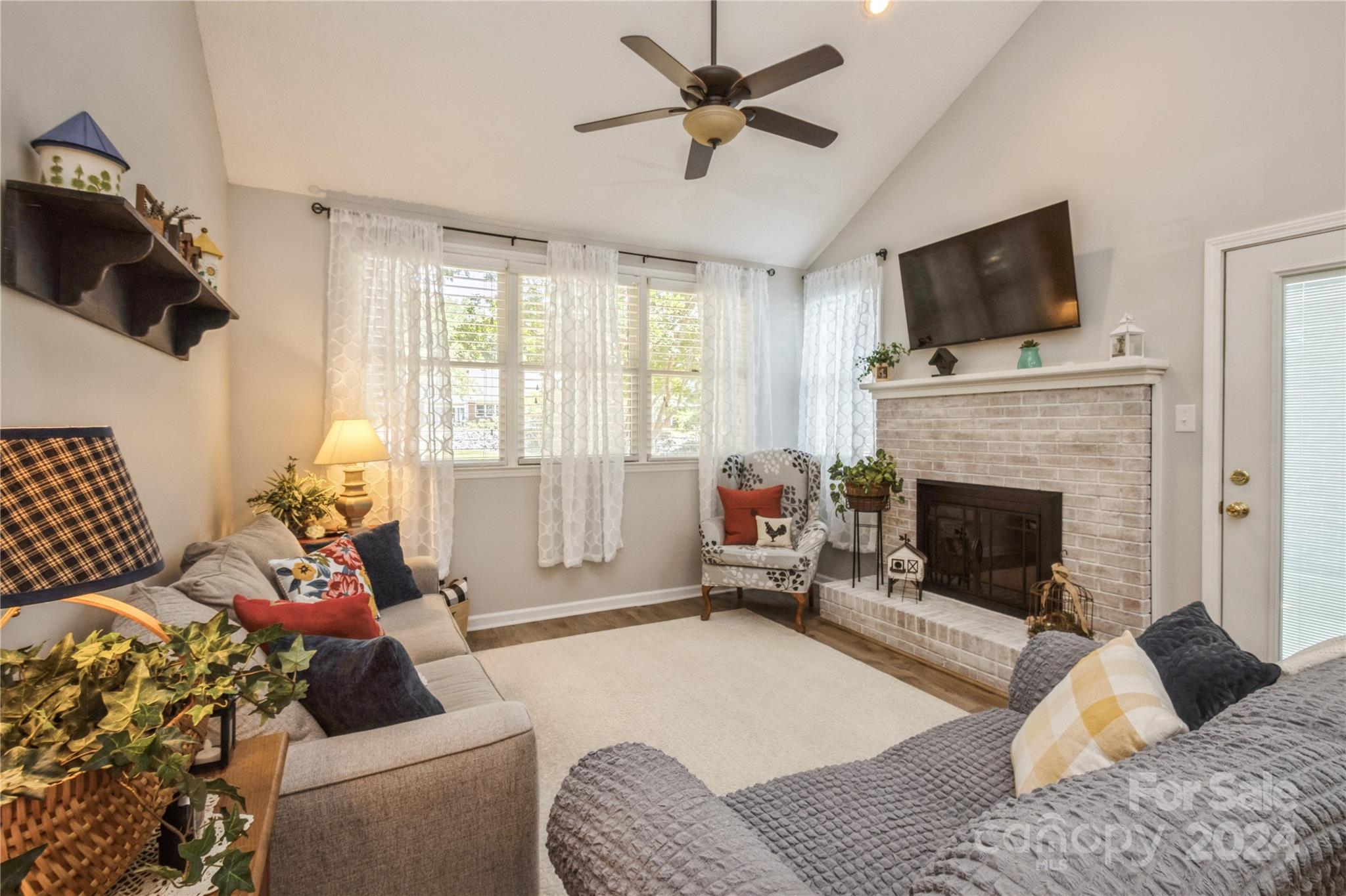 19960 Oak Leaf Circle Cornelius, NC 28031 - Photo 19 of 35 a living room with furniture fireplace and flat screen tv