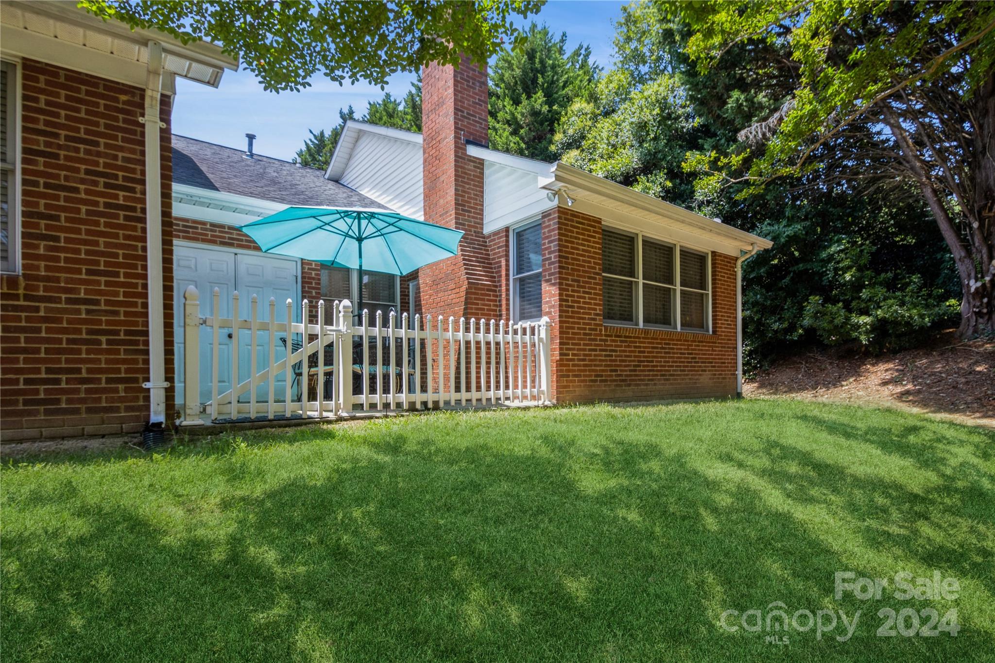 19960 Oak Leaf Circle Cornelius, NC 28031 - Photo 29 of 35 a view of a house with a yard and table under an umbrella