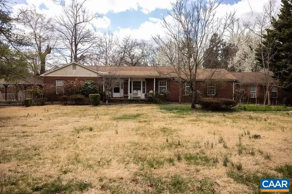 a front view of a house with a yard covered in snow