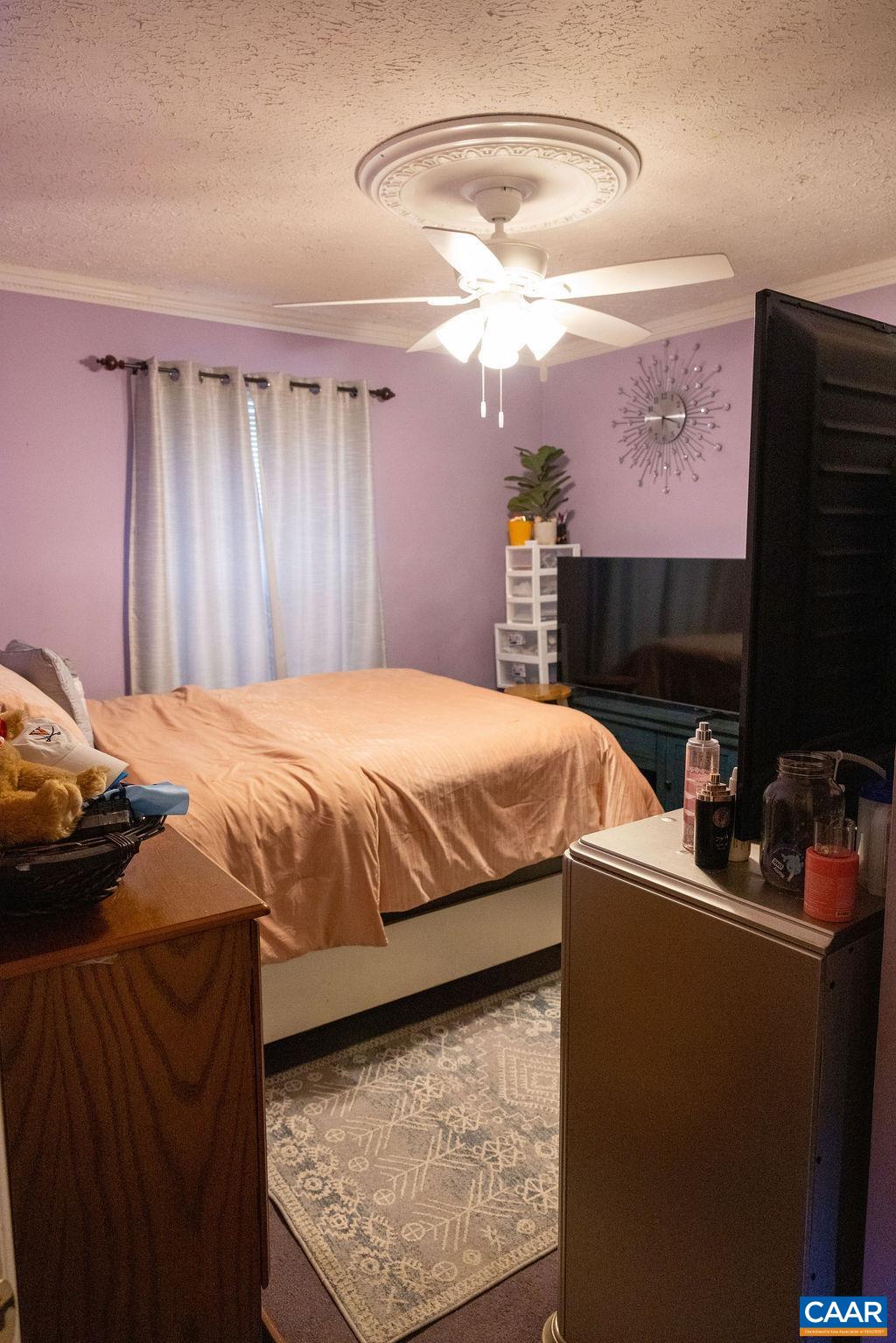 5705 Louisa Road Keswick, VA 22947 - Photo 13 of 19 a bedroom with a bed and dresser with mirror