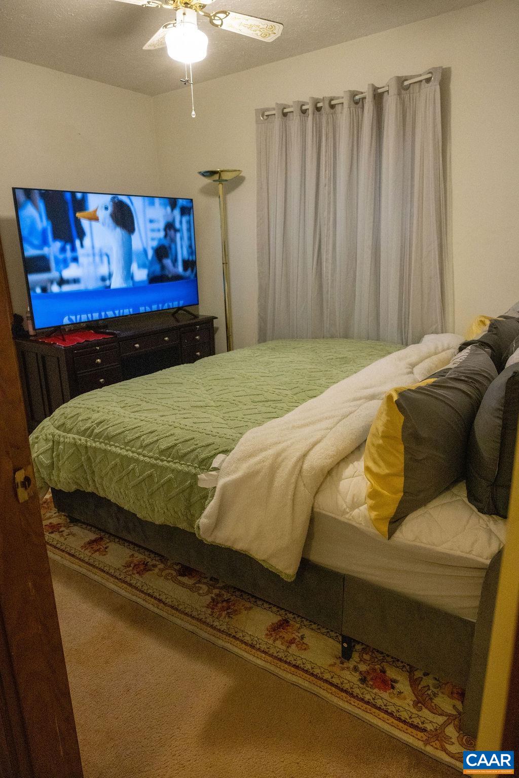 5705 Louisa Road Keswick, VA 22947 - Photo 14 of 19 a bed sitting in a bedroom next to a cabinet