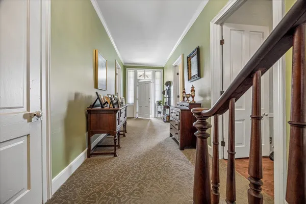 a view of an entryway with wooden floor and stairs