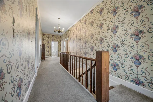 a view of a hallway with wooden floor and entryway