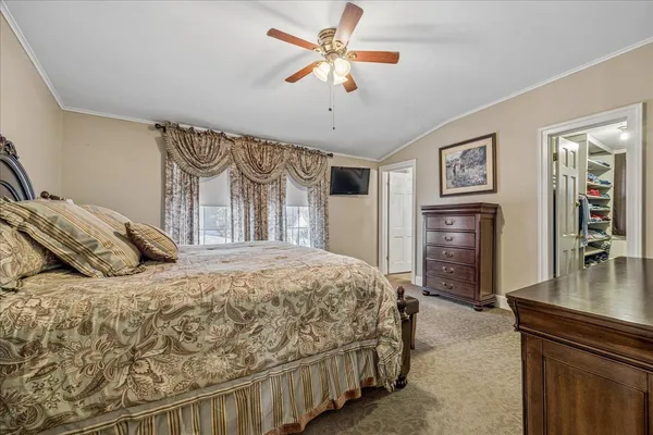 a bedroom with a bed and dresser with mirror