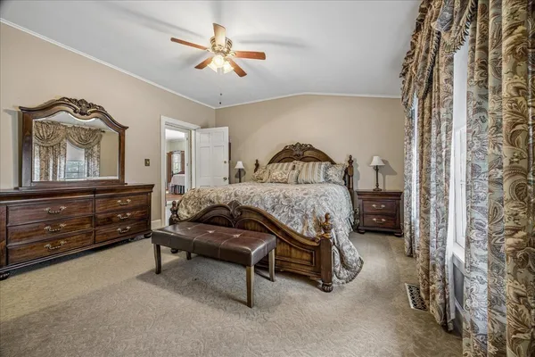 a bedroom with a bed and a chandelier