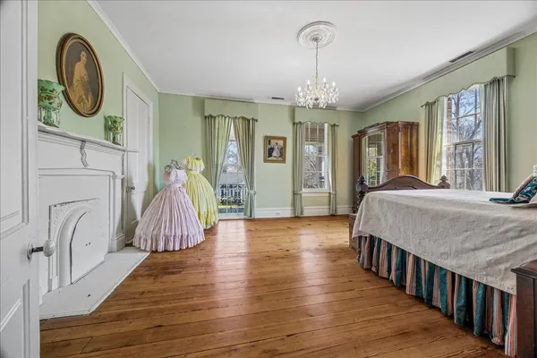 a spacious bedroom with bed and a chandelier