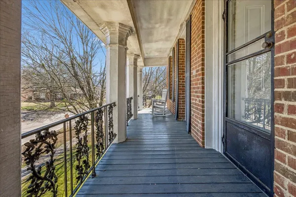 a view of a balcony with wooden floor and stairs