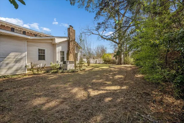 a backyard of a house with table and chairs