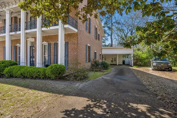 a front view of a house with a garden