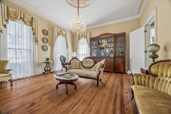 a living room with furniture and a chandelier