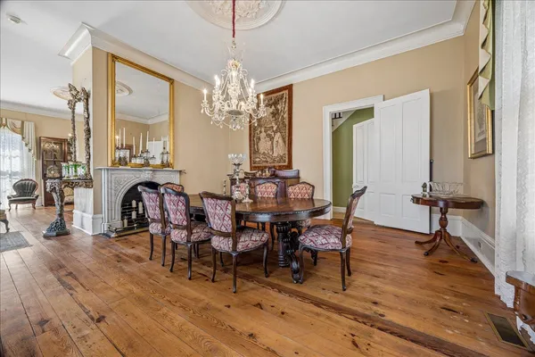 a view of a dining room with furniture and chandelier