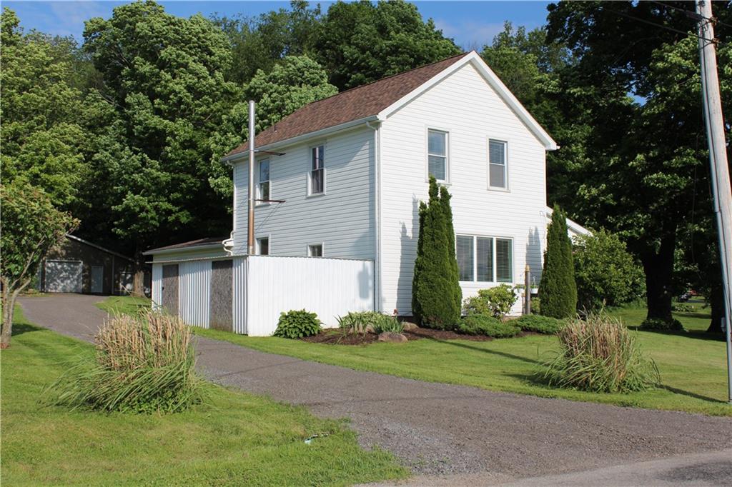 354 Airport Road Mercer, PA 16137 - Photo 23 of 25 a view of a white house next to a yard with big trees