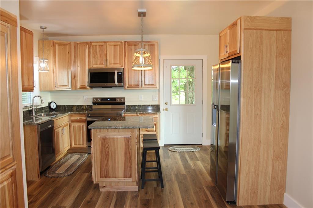 354 Airport Road Mercer, PA 16137 - Photo 6 of 25 a kitchen with stainless steel appliances granite countertop a stove refrigerator sink and microwave