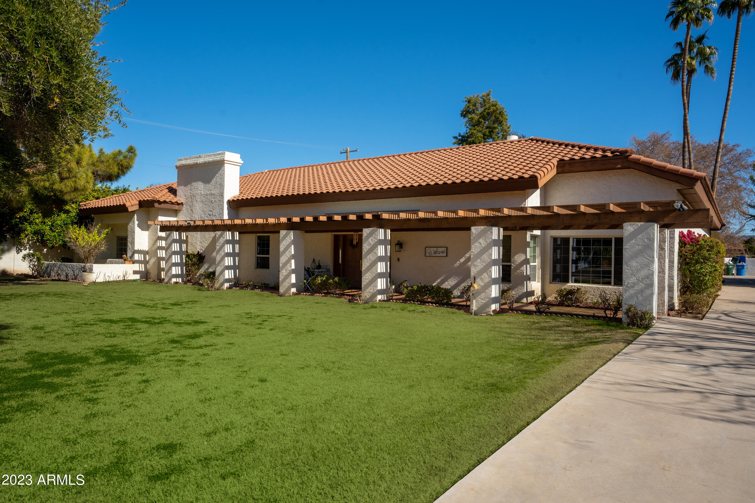a front view of a house with a garden