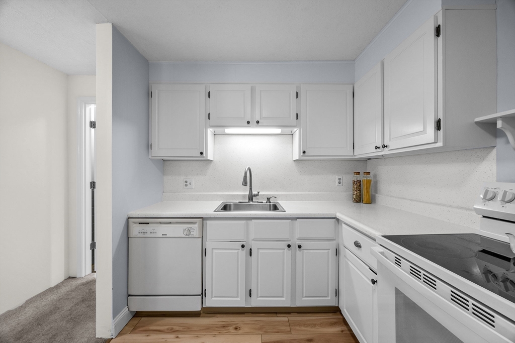 42 Old Colony Way, Unit 28 Orleans, MA 02653 - Photo 11 of 35 a kitchen with stainless steel appliances granite countertop a sink stove and cabinets