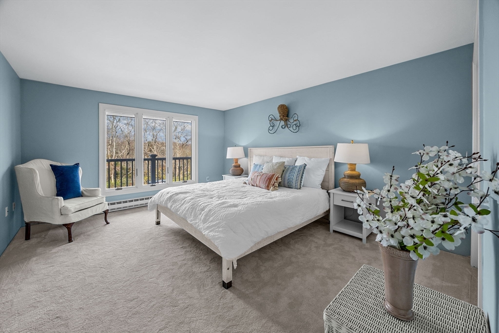 42 Old Colony Way, Unit 28 Orleans, MA 02653 - Photo 14 of 35 a bedroom with a bed and a potted plant