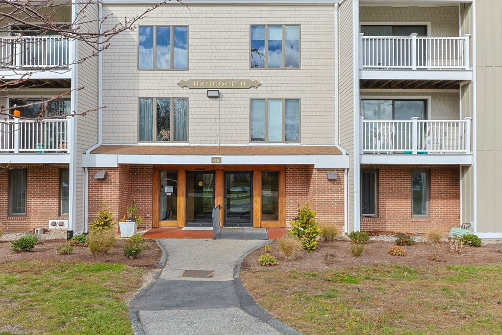 42 Old Colony Way, Unit 28 Orleans, MA 02653 - Photo 2 of 35 a front view of a building with many windows