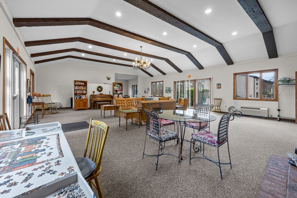 42 Old Colony Way, Unit 28 Orleans, MA 02653 - Photo 25 of 35 a living room with lots of furniture and a chandelier