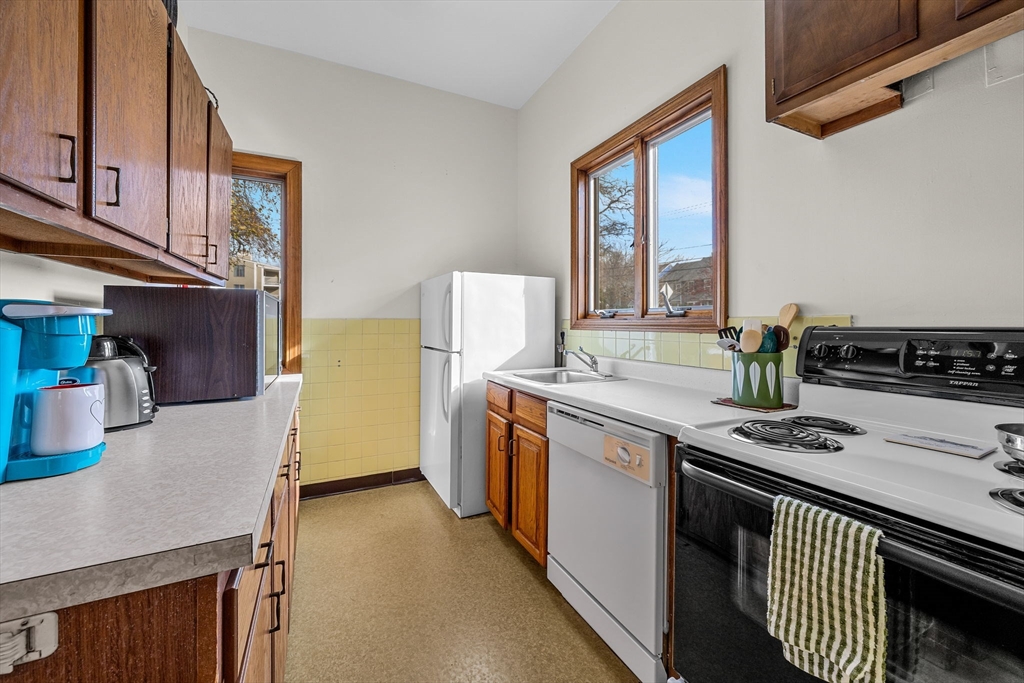 42 Old Colony Way, Unit 28 Orleans, MA 02653 - Photo 29 of 35 a kitchen with stainless steel appliances granite countertop a stove a sink dishwasher and a refrigerator