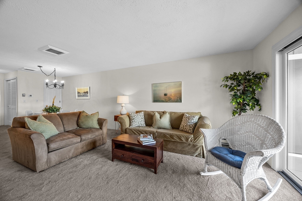 42 Old Colony Way, Unit 28 Orleans, MA 02653 - Photo 7 of 35 a living room with furniture and a potted plant