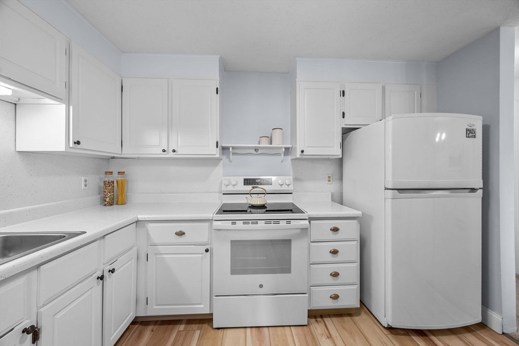 42 Old Colony Way, Unit 28 Orleans, MA 02653 - Photo 10 of 35 a kitchen with cabinets appliances and a counter space