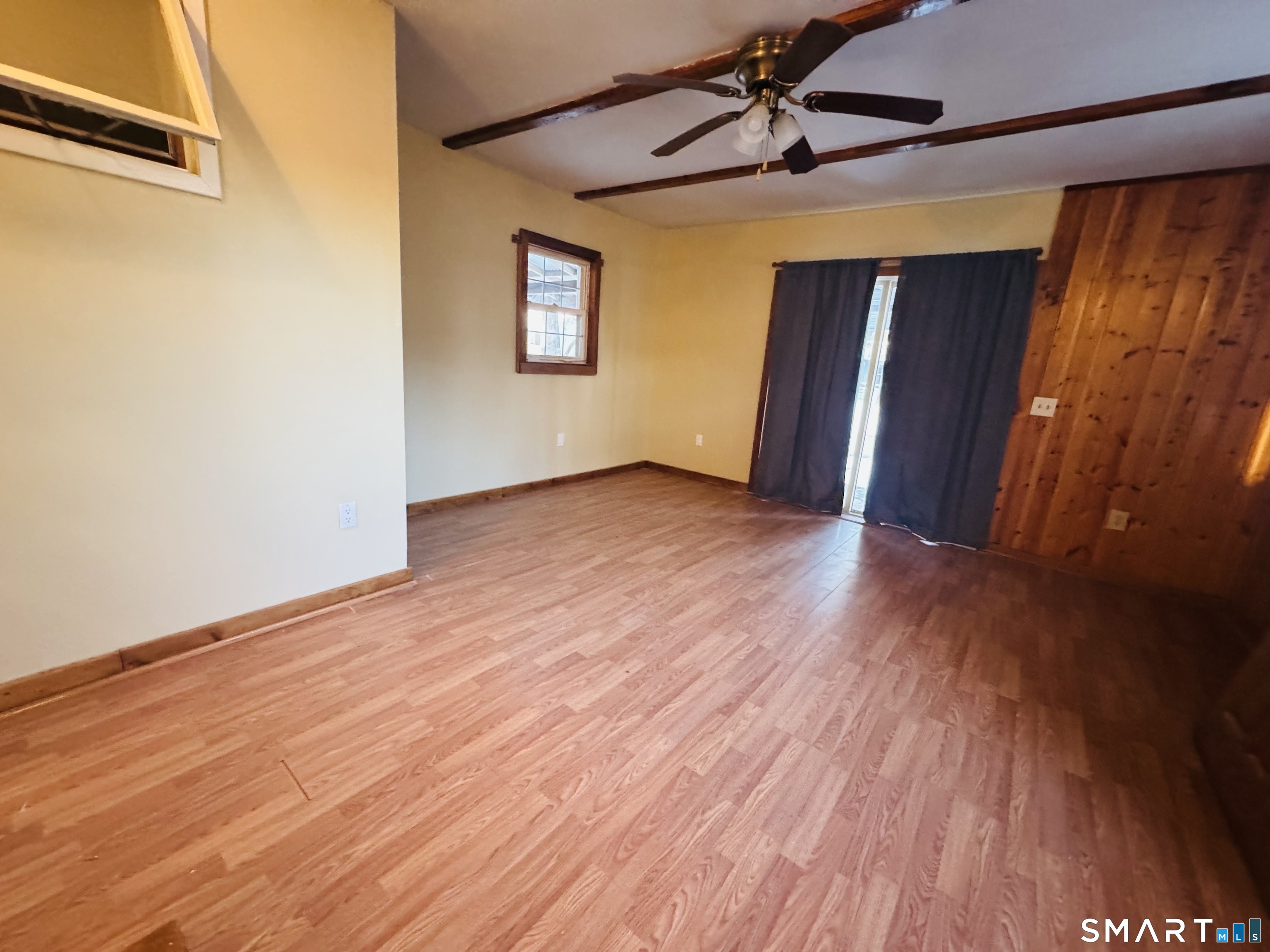 23 High Street Plainfield, CT 06354 - Photo 15 of 22 a view of an empty room with wooden floor and a window