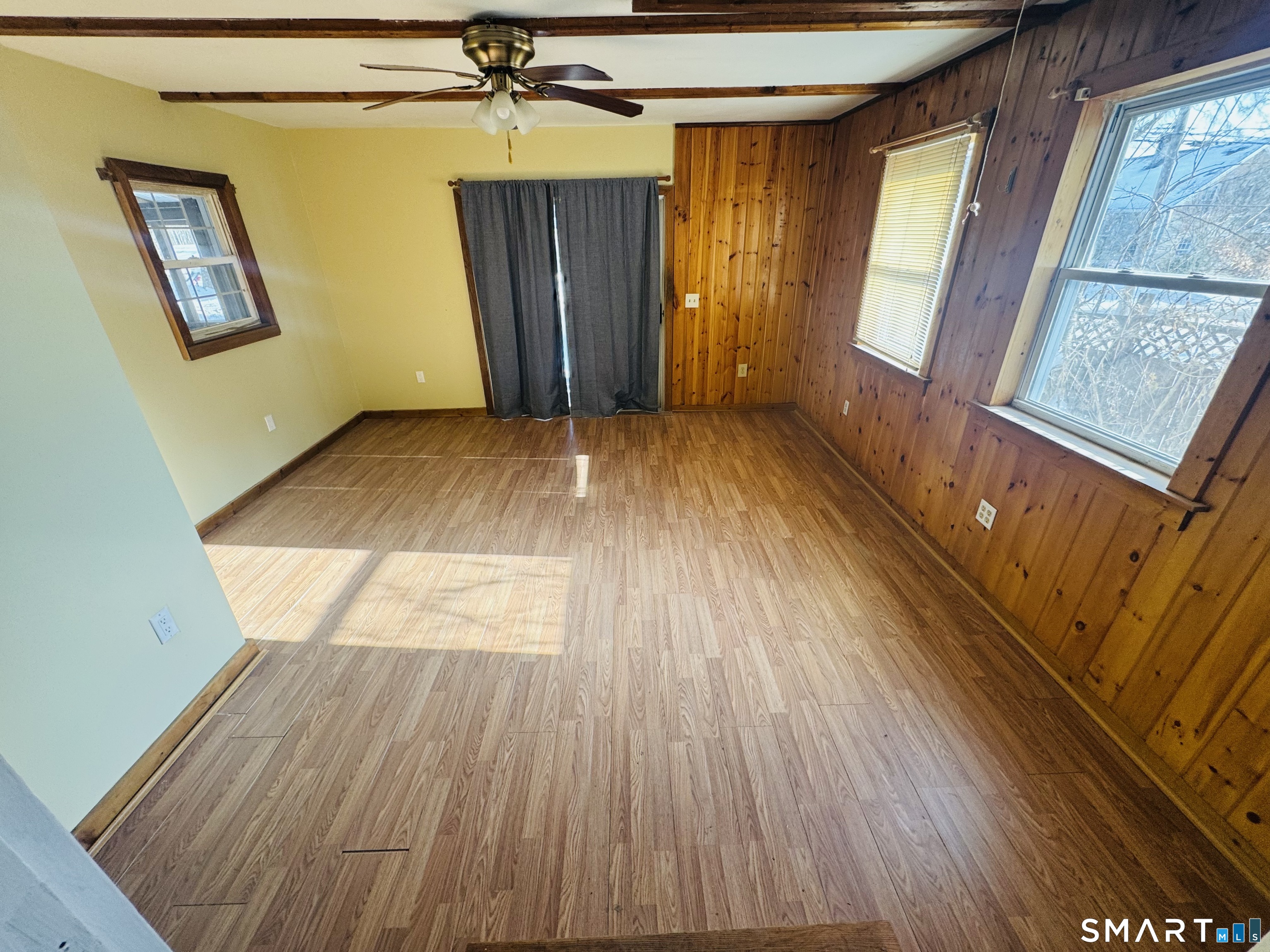 23 High Street Plainfield, CT 06354 - Photo 5 of 22 a view of empty room with wooden floor and fan