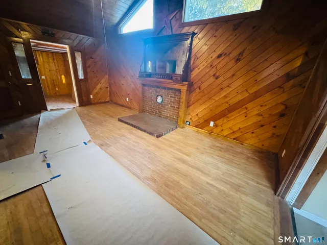 a large kitchen with stainless steel appliances granite countertop a refrigerator a sink and dishwasher a oven with wooden cabinets