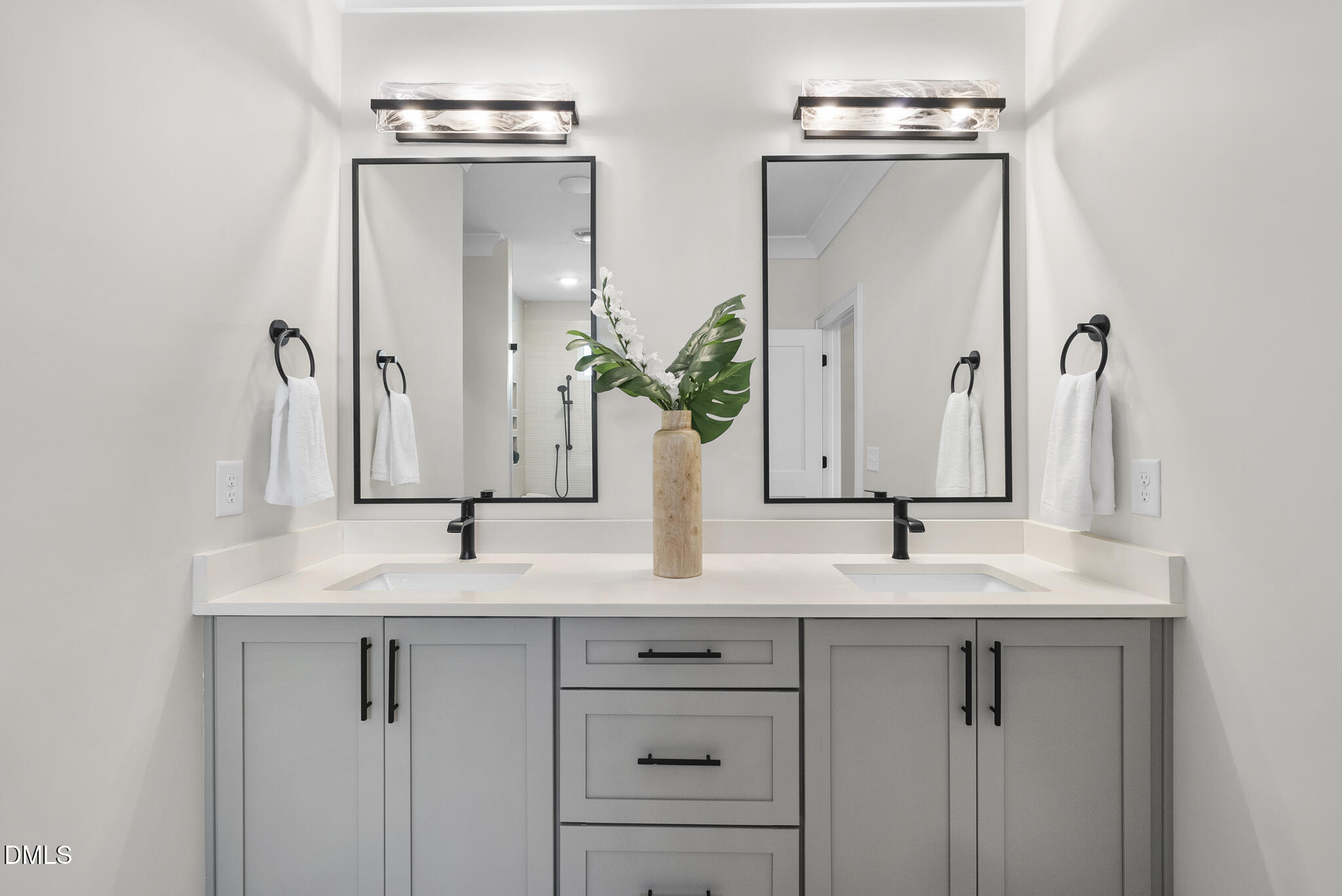 1003 Canterbury Road Raleigh, NC 27607 - Photo 18 of 45 a bathroom with double sink and a mirror