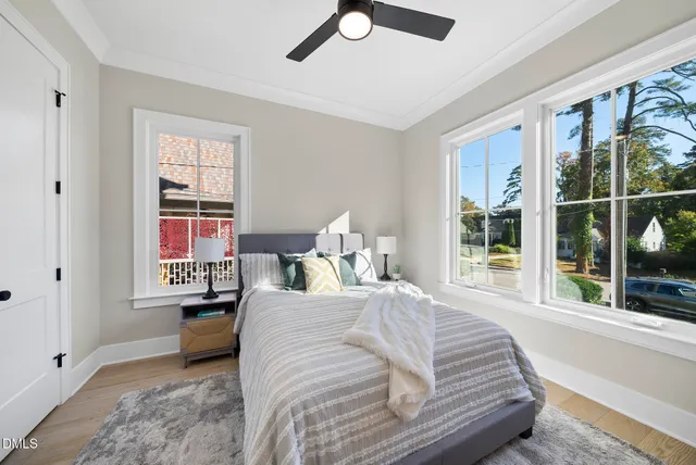 a view of empty room with wooden floor and window