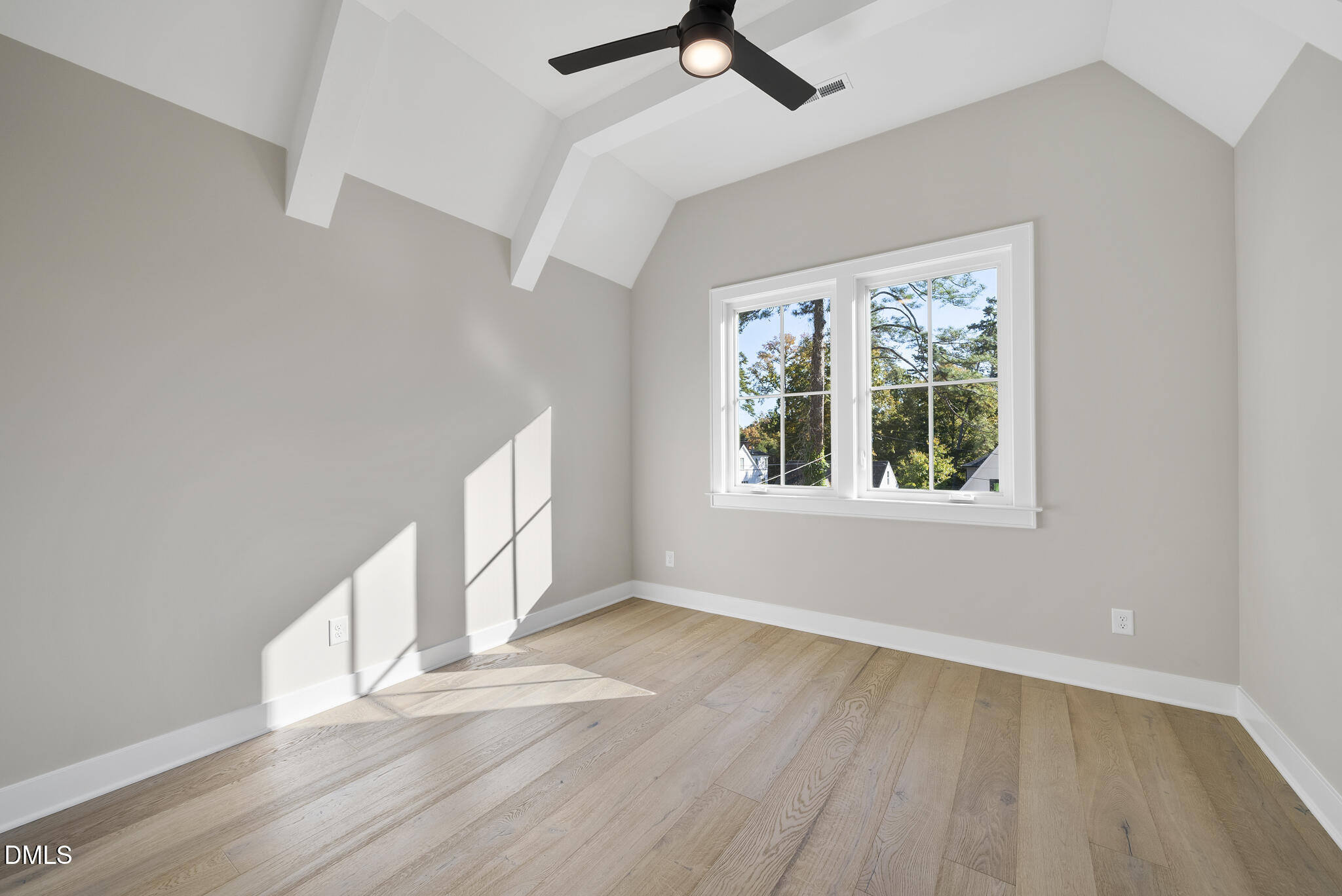 1003 Canterbury Road Raleigh, NC 27607 - Photo 26 of 45 a view of an empty room with wooden floor and a window
