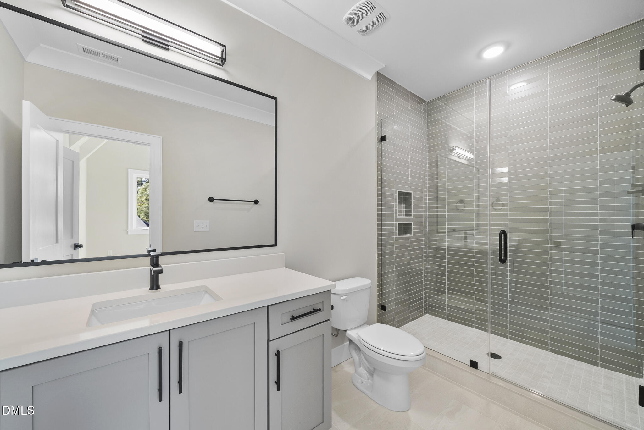 1003 Canterbury Road Raleigh, NC 27607 - Photo 28 of 45 a bathroom with a sink a toilet and shower
