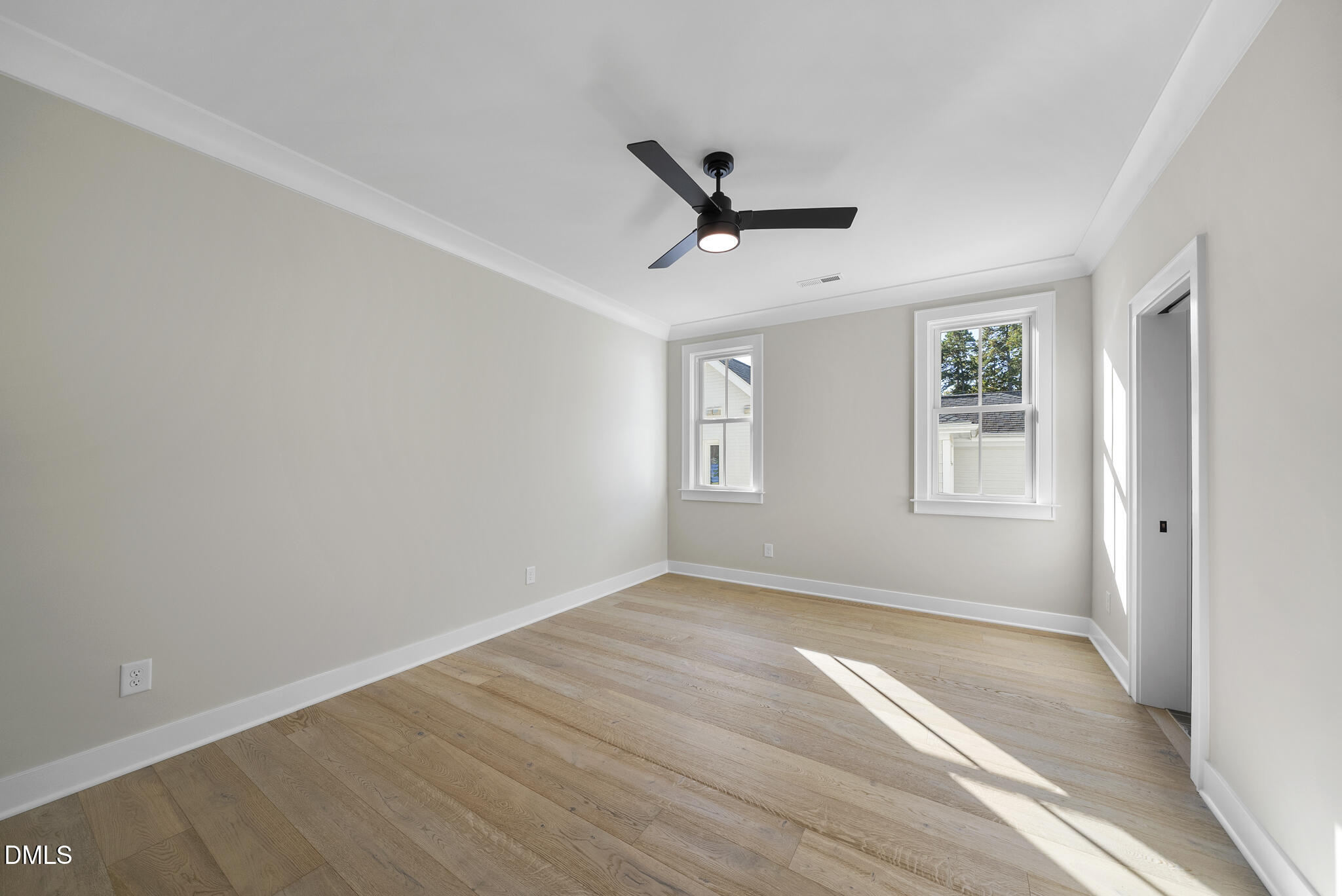 1003 Canterbury Road Raleigh, NC 27607 - Photo 29 of 45 a view of empty room with wooden floor and window