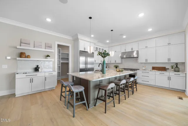 a kitchen with kitchen island cabinets and wooden floor