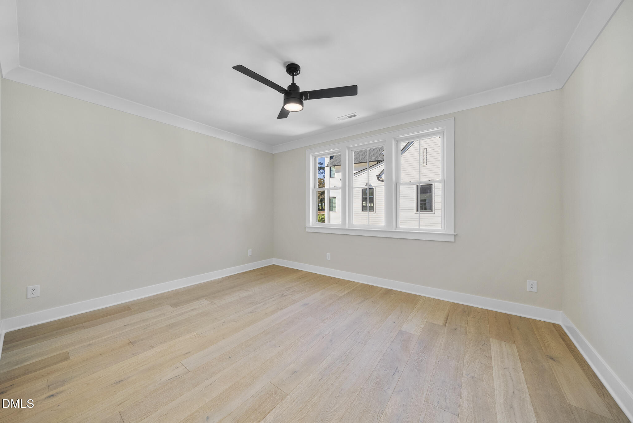 1003 Canterbury Road Raleigh, NC 27607 - Photo 34 of 45 a view of empty room with wooden floor and fan