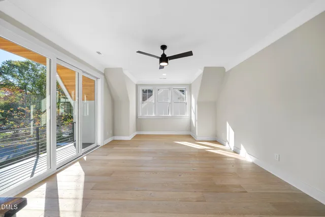 a view of an empty room with a fireplace and a window