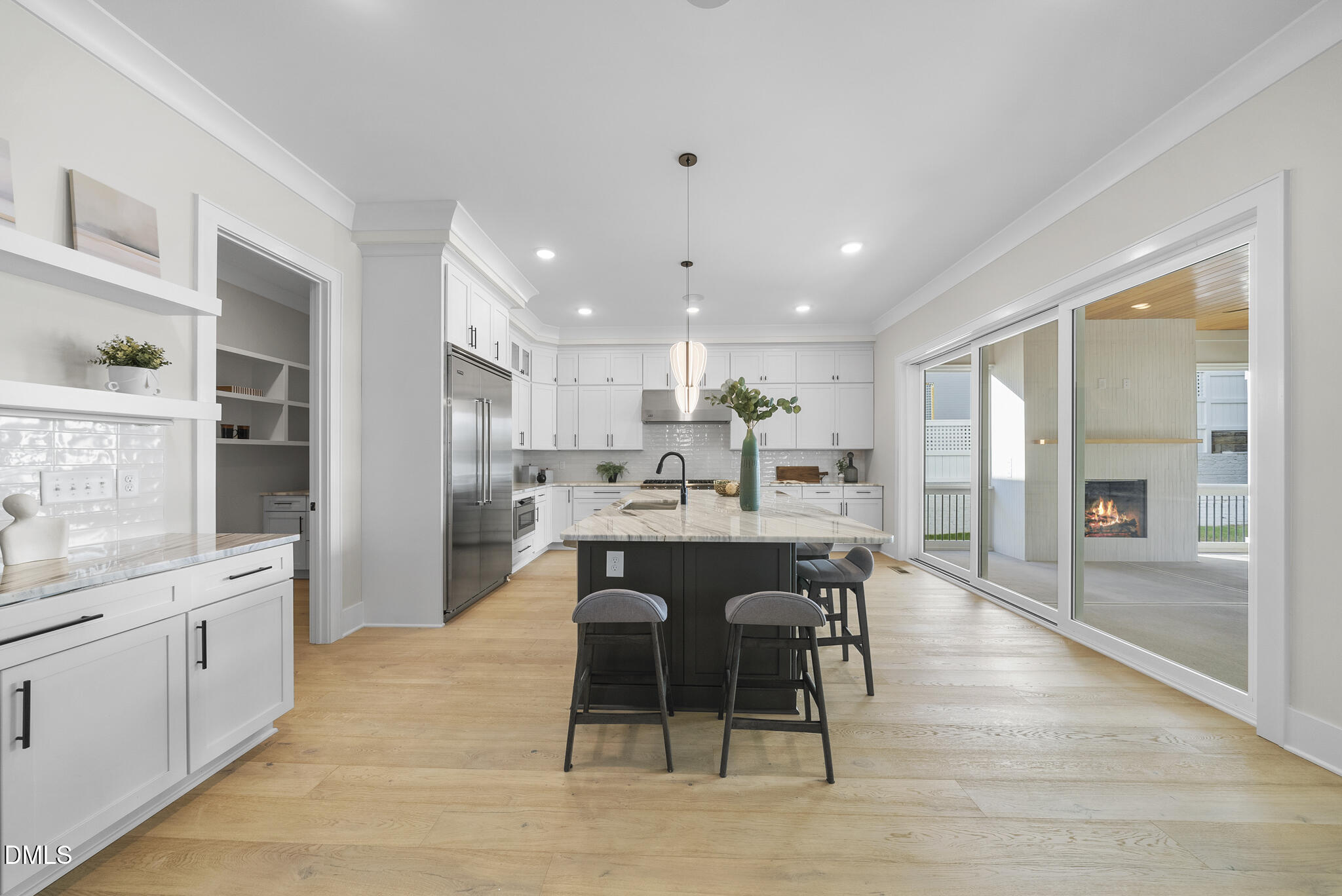 1003 Canterbury Road Raleigh, NC 27607 - Photo 5 of 45 a kitchen with stainless steel appliances kitchen island granite countertop a table chairs sink and cabinets