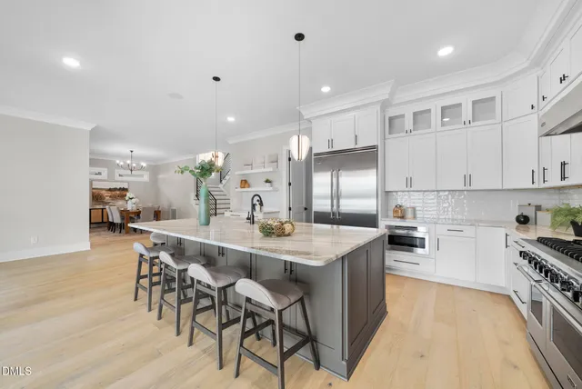 a kitchen with stainless steel appliances kitchen island granite countertop a sink and cabinets