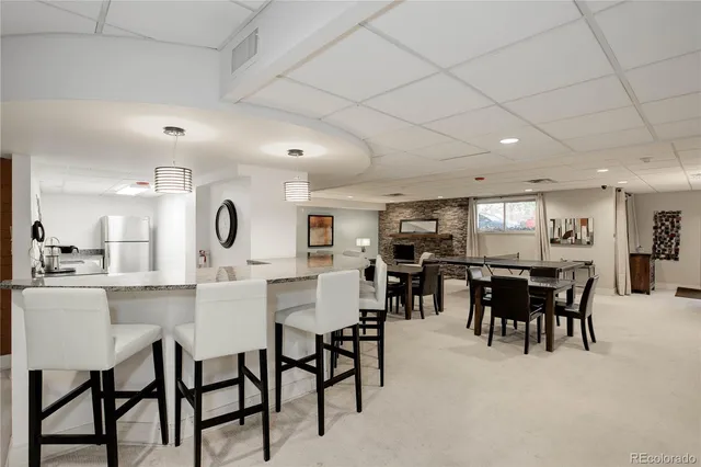 a kitchen with a dining table chairs and white cabinets