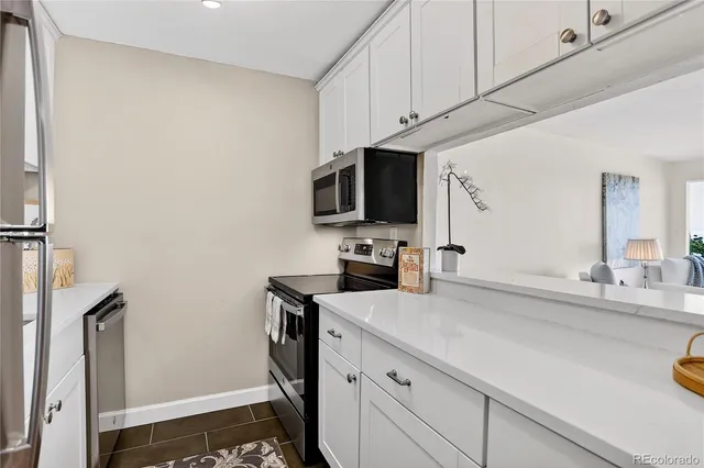 a kitchen with stainless steel appliances a sink microwave and stove