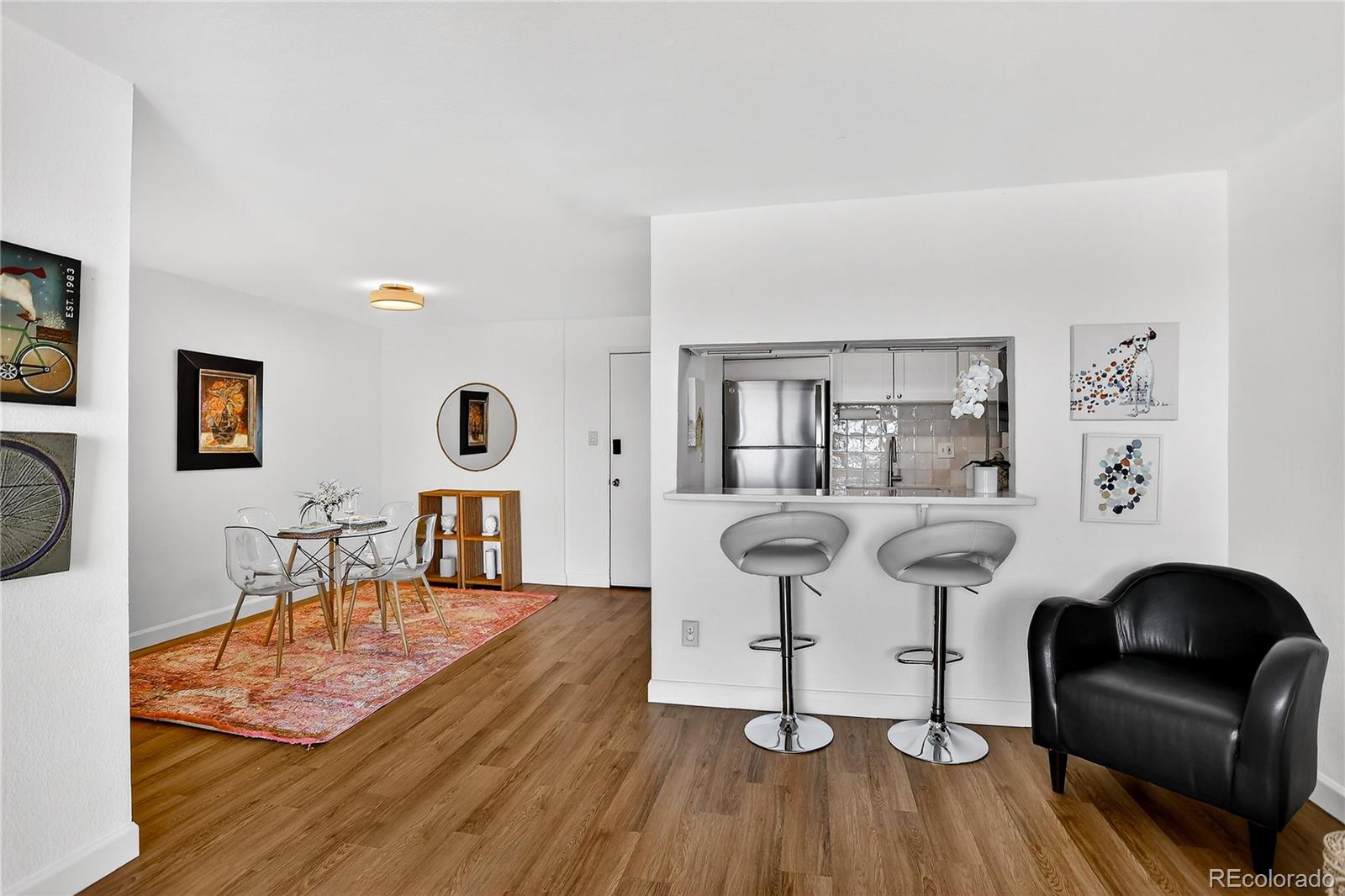 2 Adams Street, Unit 1401 Denver, CO 80206 - Photo 7 of 21 a dining room with furniture and wooden floor