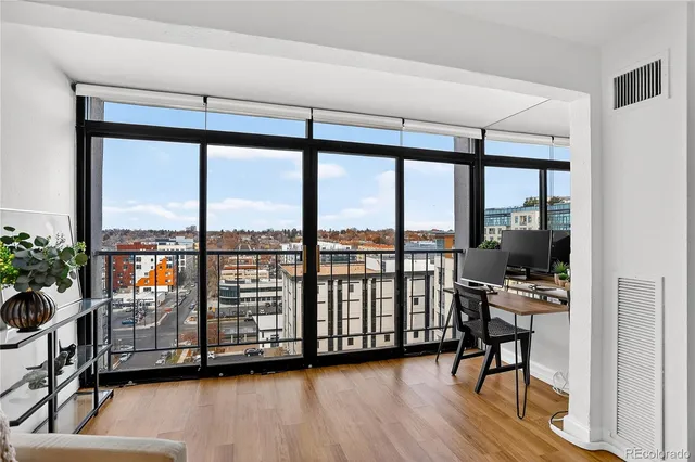 a view of a room with wooden floor and furniture